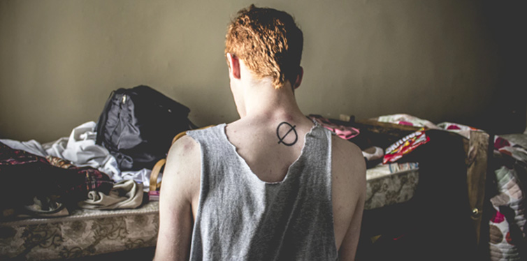 man sitting near the bed