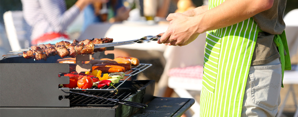 man cooking using outdoor grill
