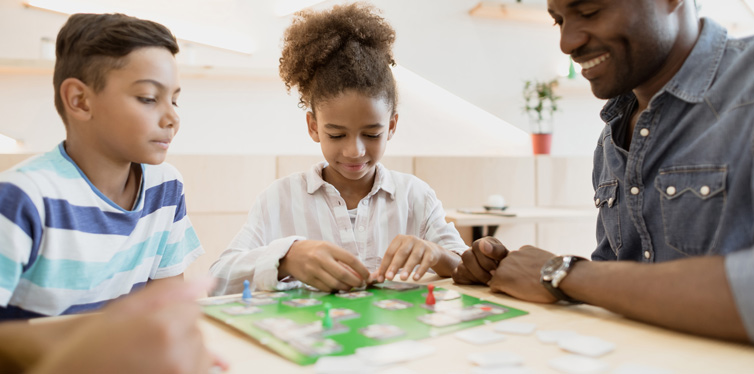 family playing board game