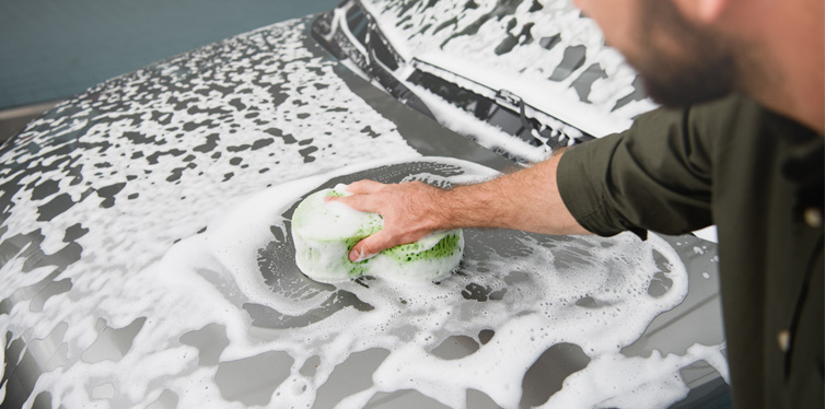 man cleaning his car