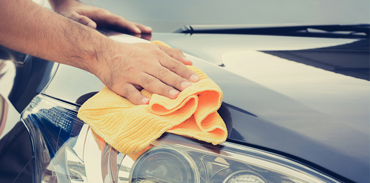 man polishing his car
