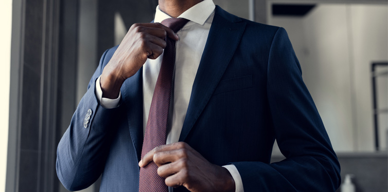 man putting on his tie