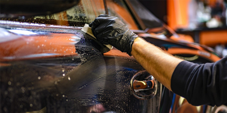 man washing a car