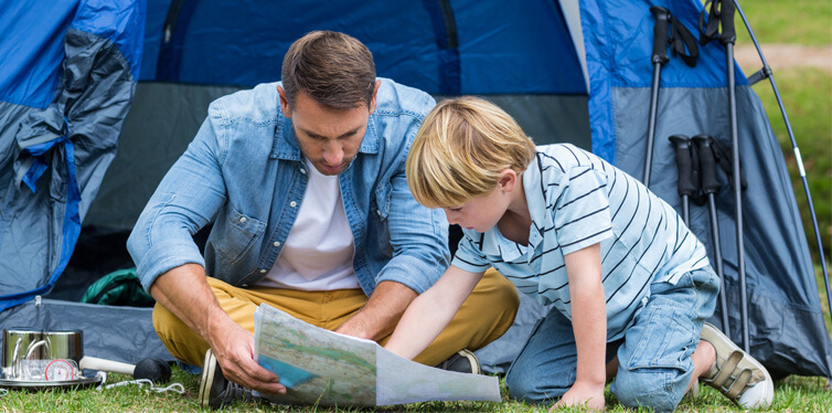 father and son reading a map
