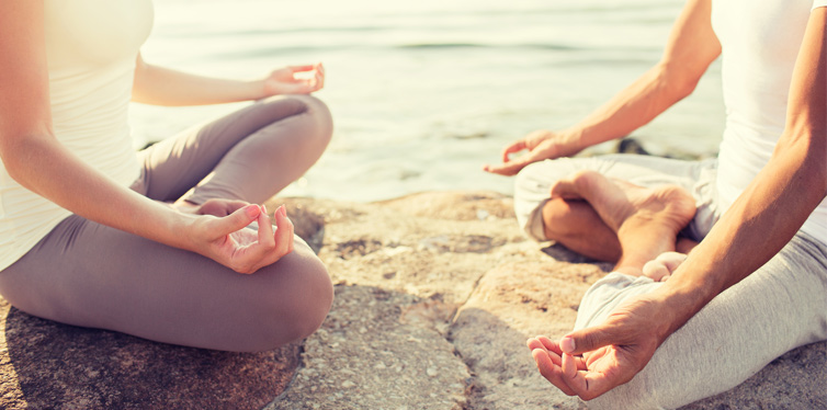 man and woman practicing yoga