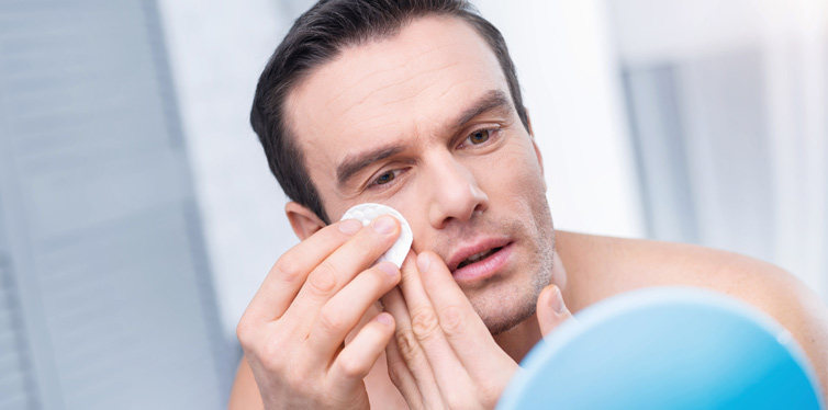 man cleaning his face