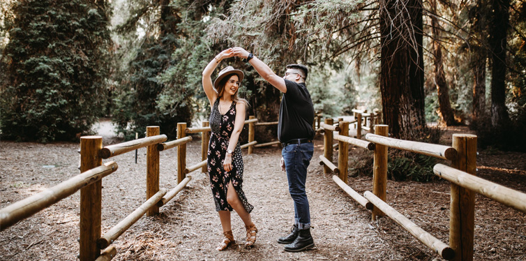 man and woman dancing between brown wooden handrails