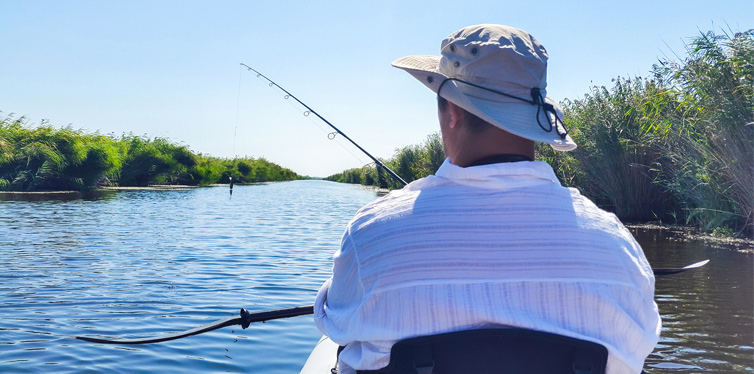 man fishing in kayak