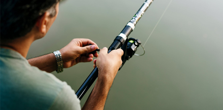 man fishing on the river