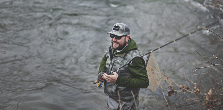 man wearing fishing vest and sunglasses