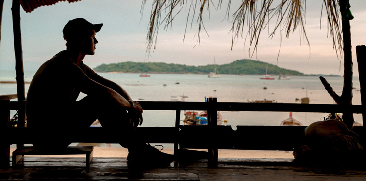 man sitting on chair at the cottage