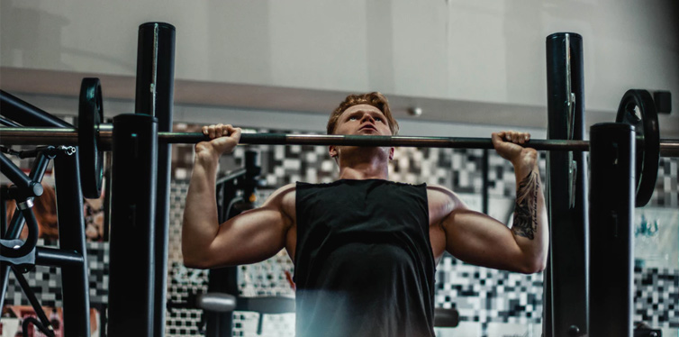 man lifting barbell