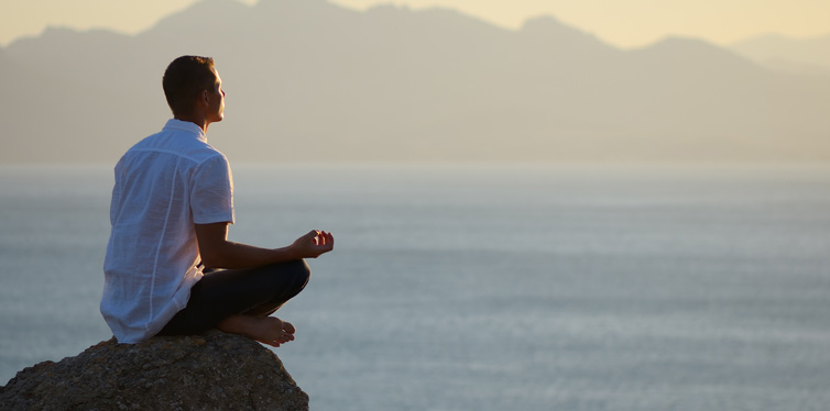 man meditating outdoors