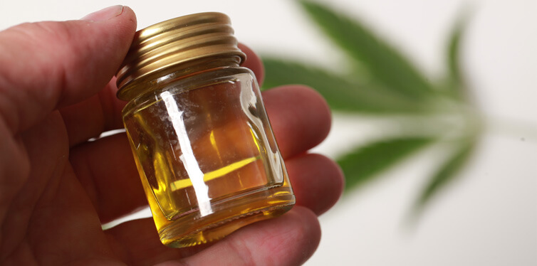person holding cannabis oil