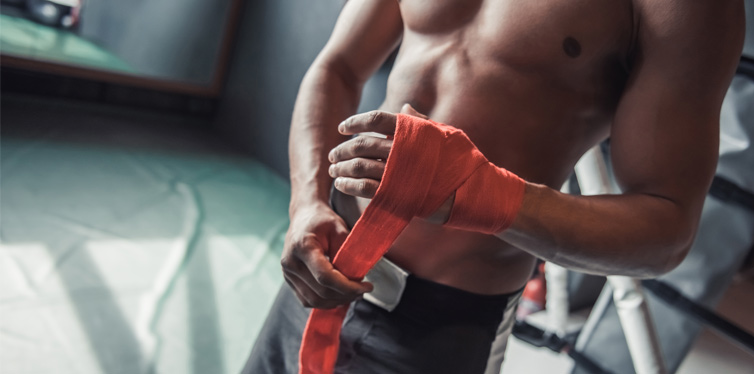 handsome boxer wrapping hands