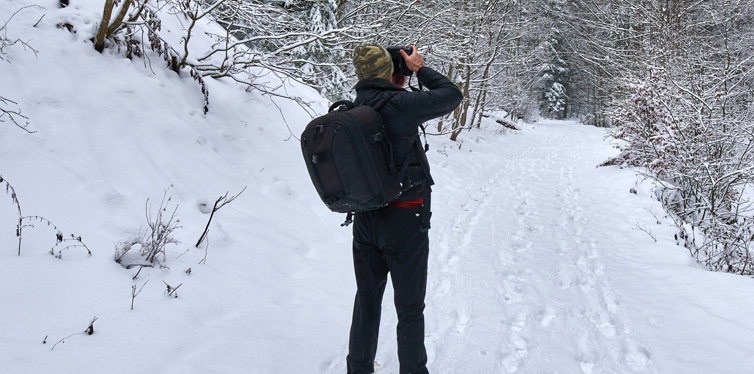 man taking photos in the winter