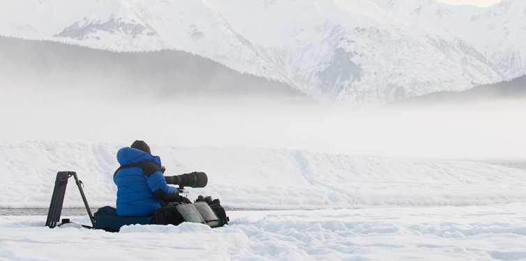 photographer sitting in the snow