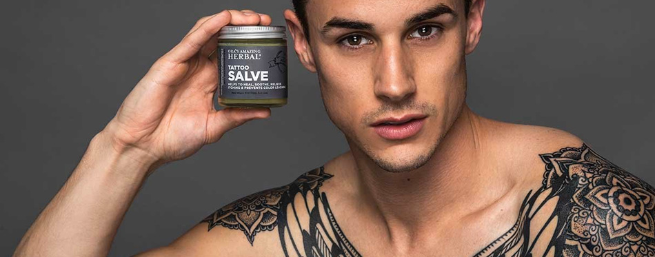 man holding tattoo lotion