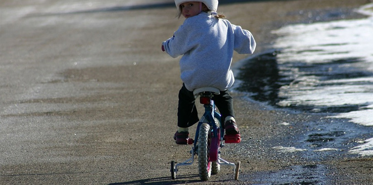 a girl learning how to ride a bike