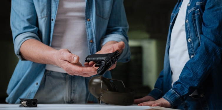 man showing a gun to a kid