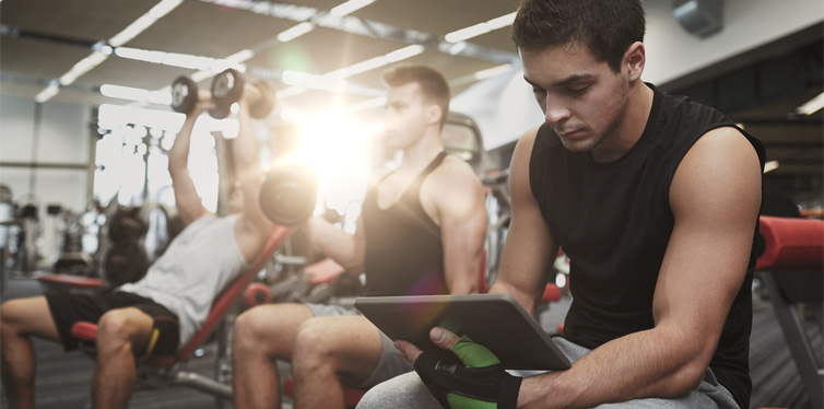 man holding tablet at the gym