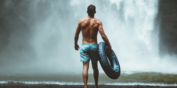 man in blue shorts with tire