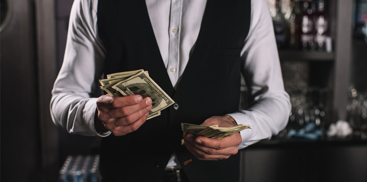 a waiter counting the tips