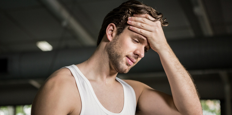 man after workout wiping his face