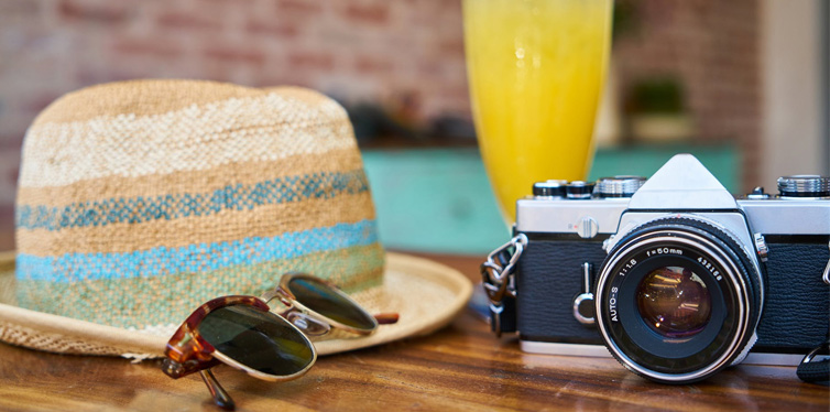 hat sunglasses and camera