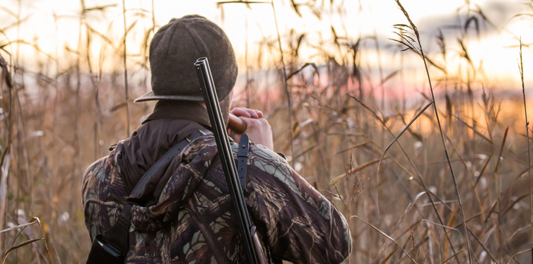 hunter with a gun and duck call