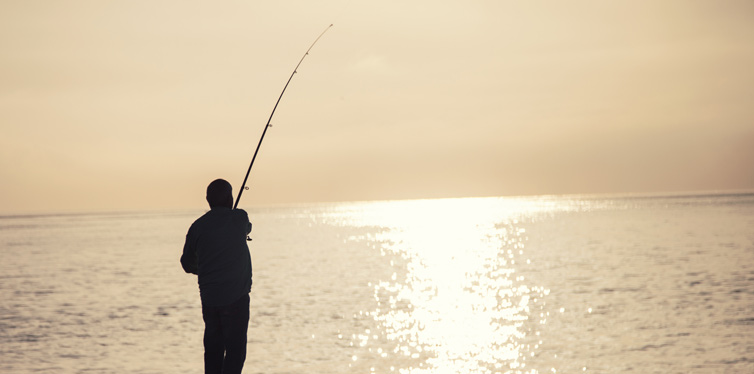 man fishing at sea