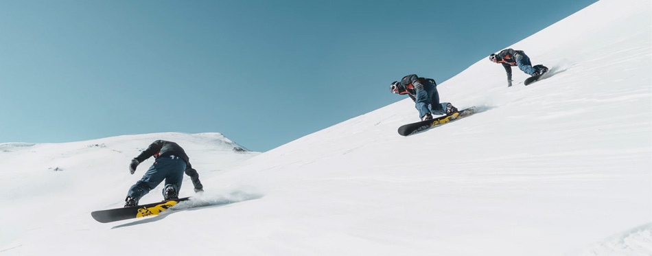 man riding snowboards