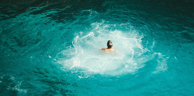 man swimming in the sea