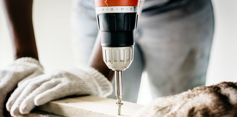 man using a drill