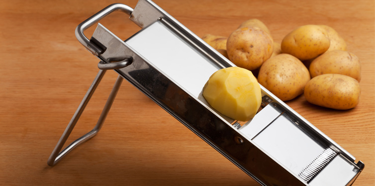 potatoes in a slicer