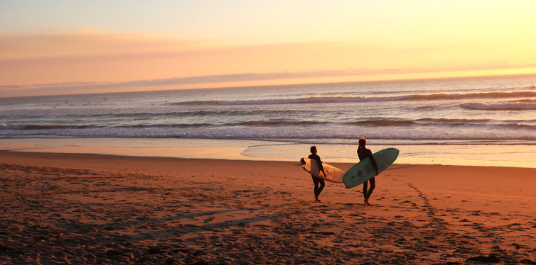 two surfers at dusk 
