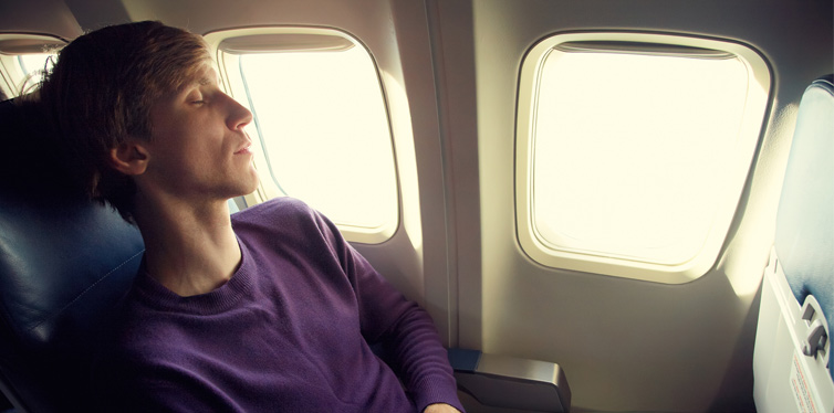 young man sleeping in a plane