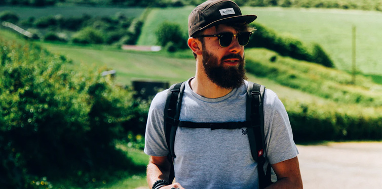 bearded man in t shirt and hat