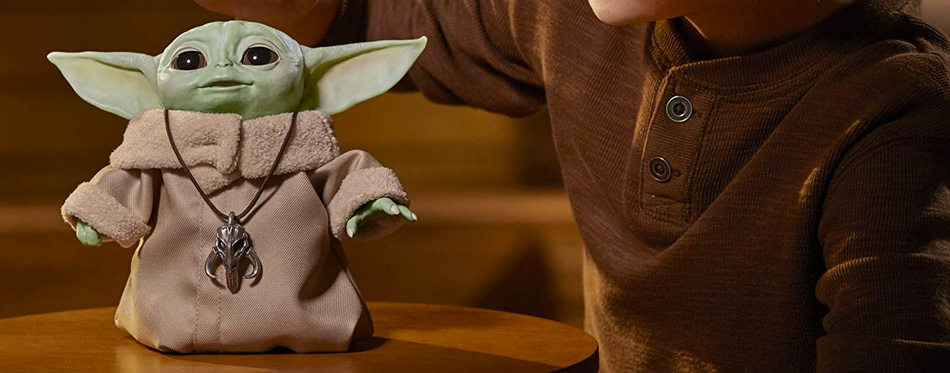 baby yoda mandalorian toy on a table