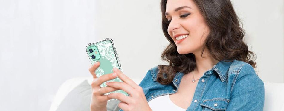 woman smiling holding an phone with iphone 12 case