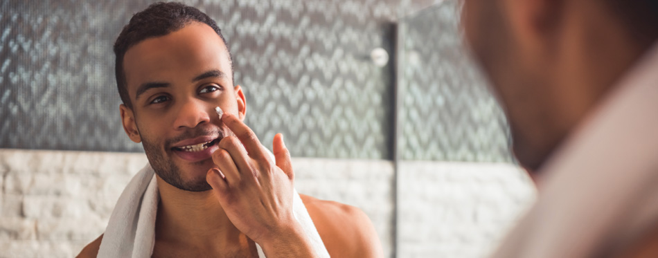 man applying face cream