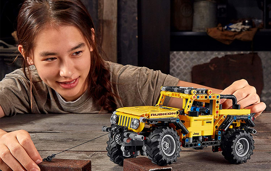 girl playing with lego technic