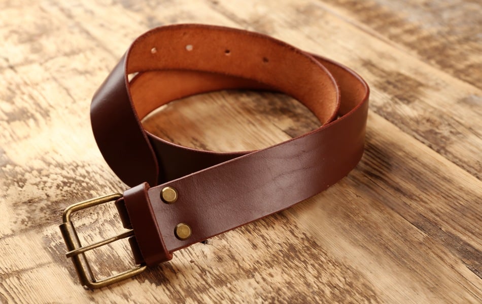 leather belt on wooden surface
