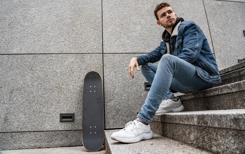 man in stretch jeans sitting on stairs