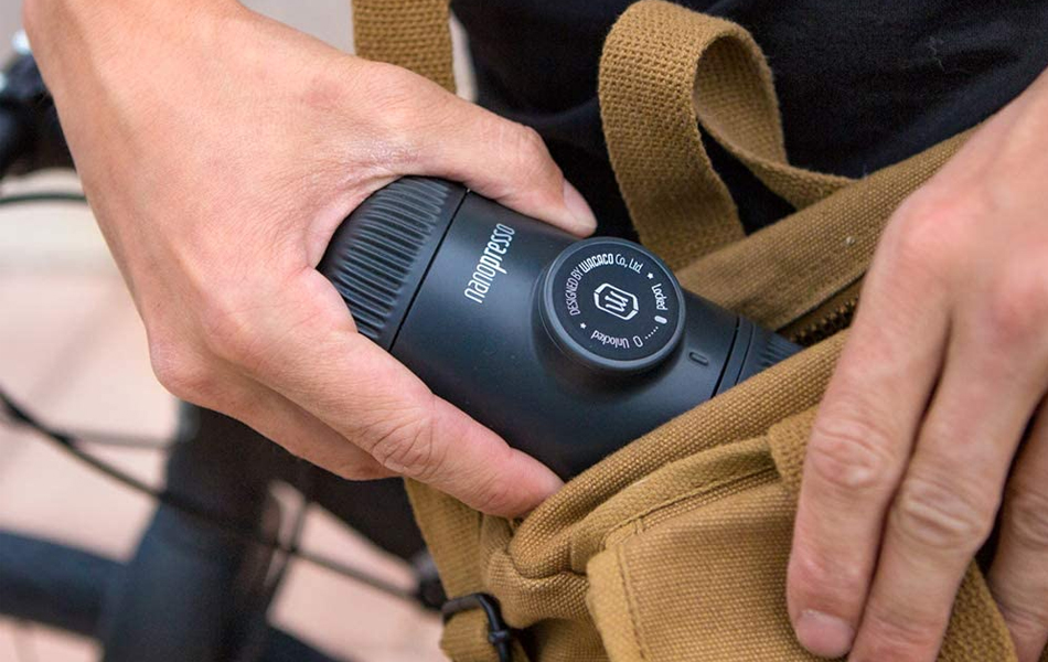 man putting manual espresso maker into the bag