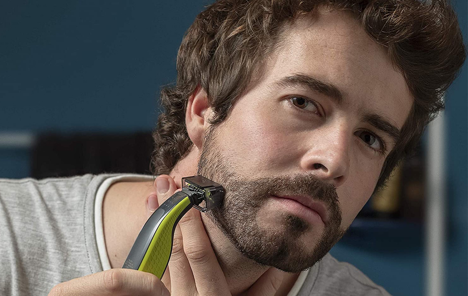 man shaving with beard trimmer