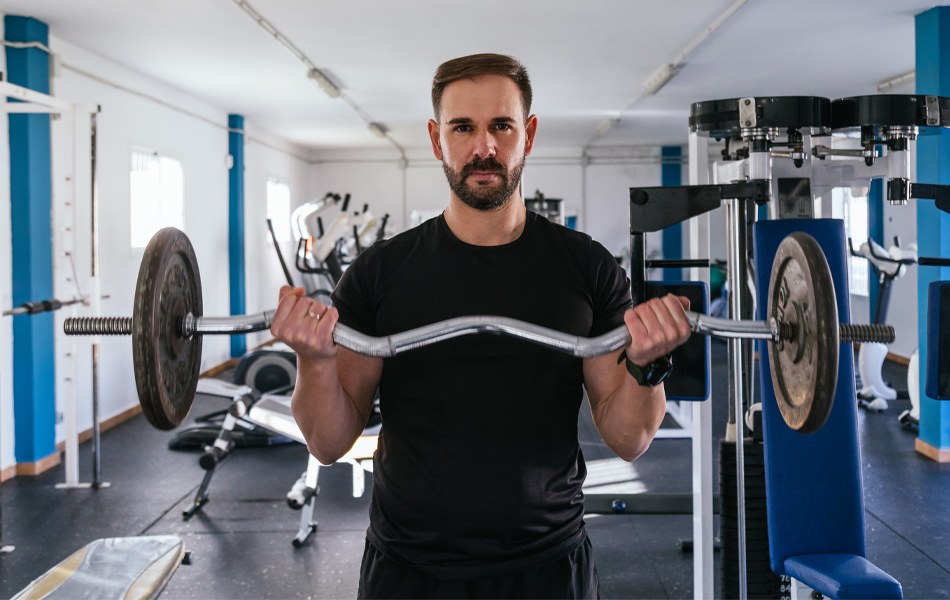 man with a curl bar