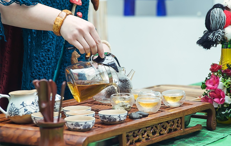 person pouring tea from tea maker