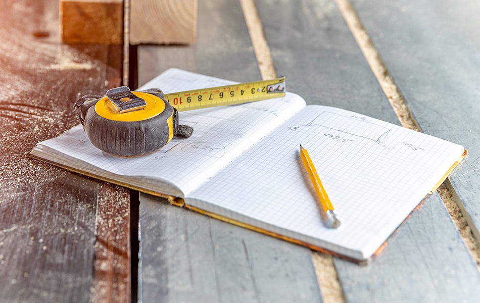 tape measure, pencil and notebook