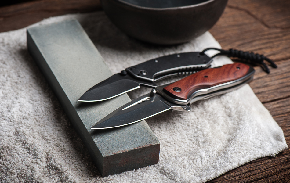two folding knives and sharpener